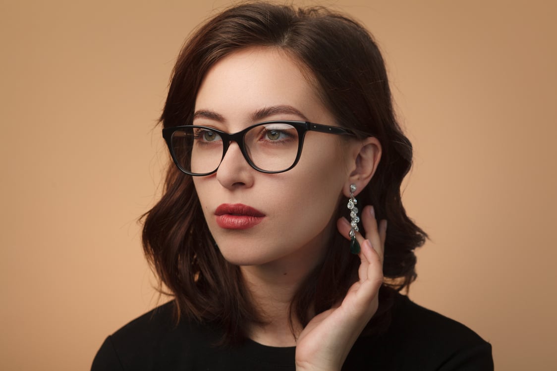 Confident pretty model wearing glasses